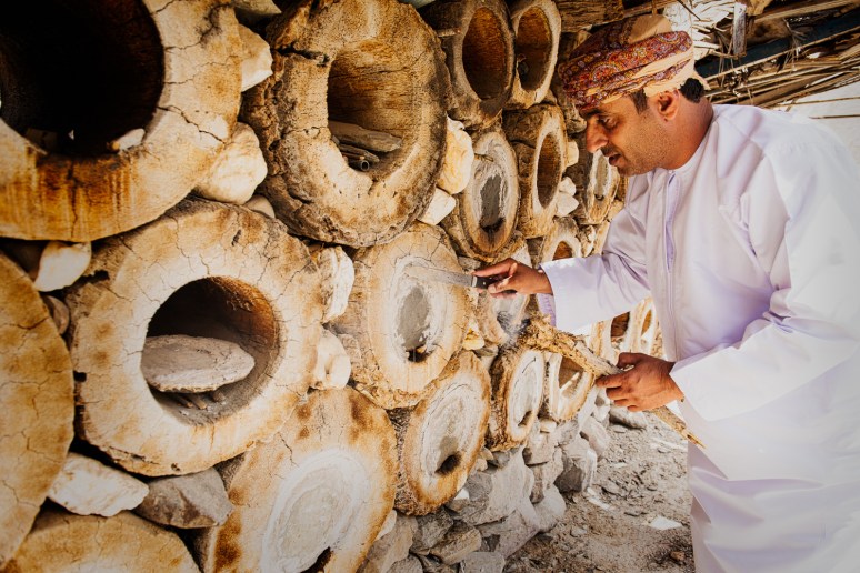 Awad AlAwfi opening one of the bee hives looking for honey