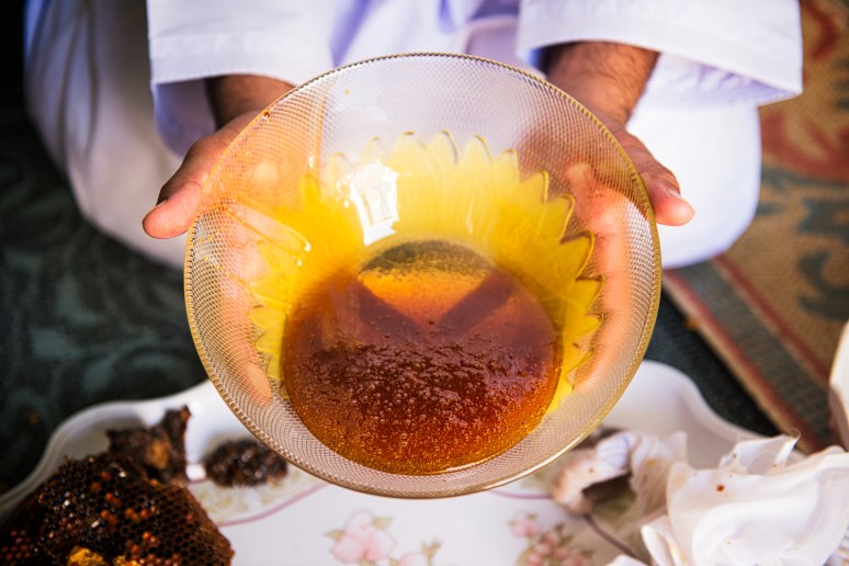 Awad presenting a fresh ball of Omani honey